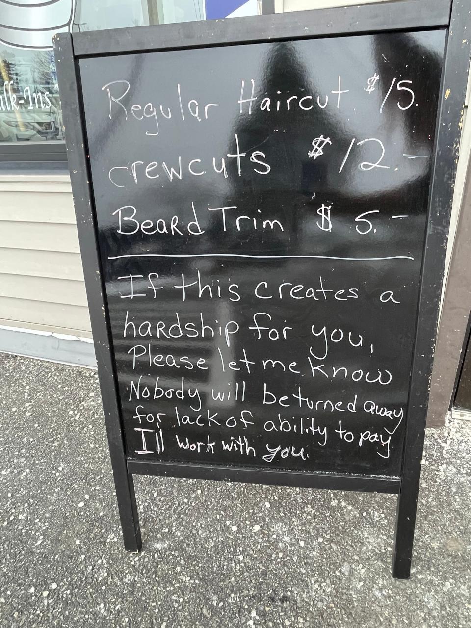 Lynn Cressey, owner of A Little Off the Top barbershop in Brunswick, Maine, added a note to the sign outside her storefront informing customers they won't be turned away if they can't afford to pay for a haircut.