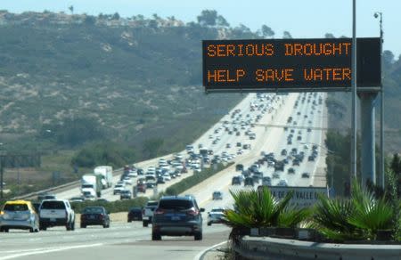 A digital traffic sign usually used for commuter travel information informs travellers southbound on interstate highway 5 to conserve water as they pass through Del Mar, California September 10, 2014. REUTERS/Mike Blake