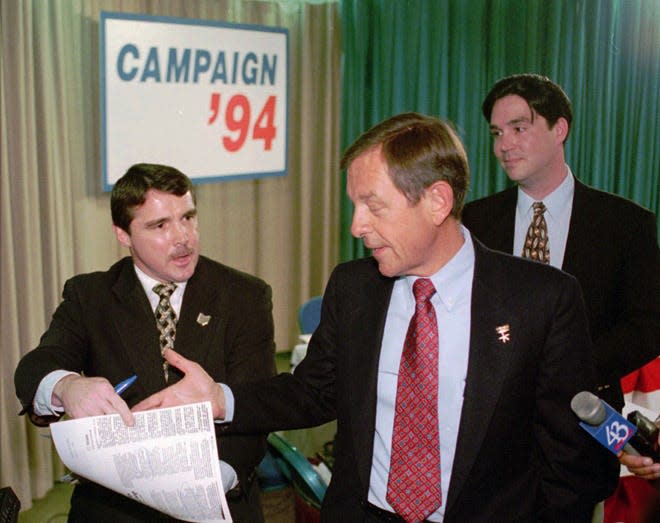 Democratic challenger Rob Burch, left, argues with Ohio Gov. George Voinovich, center, about a magazine article on the state's economic growth following the taping of a debate at Lakeland Community College in Kirtland, Ohio, Tuesday, Oct. 4, 1994. (AP Photo/Mark Duncan)