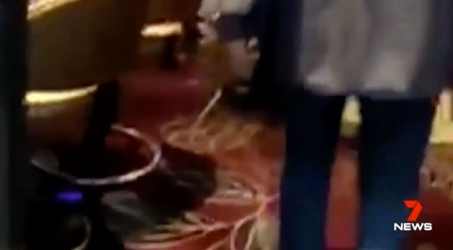 Footage shows the man walking through the venue holding the weapon. Photo: 7 News