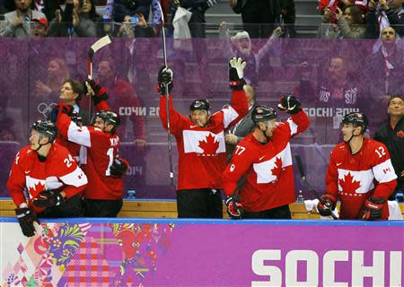 Canada's bench celebrates during their men's semi-final ice hockey victory over Team USA at the 2014 Sochi Winter Olympic Games, February 21, 2014. REUTERS/Gary Hershorn