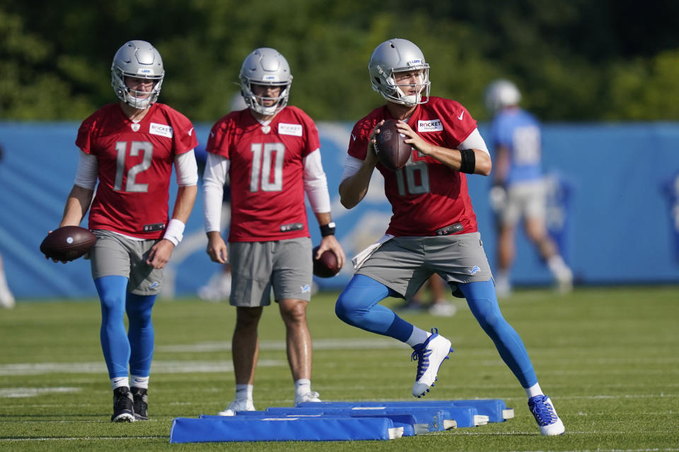 Detroit Lions quarterbacks Jared Goff, right, David Blough (10) and Tim Boyle (12) run through a drill at the Lions NFL football camp practice, Wednesday, July 28, 2021, in Allen Park, Mich. (AP Photo/Carlos Osorio)