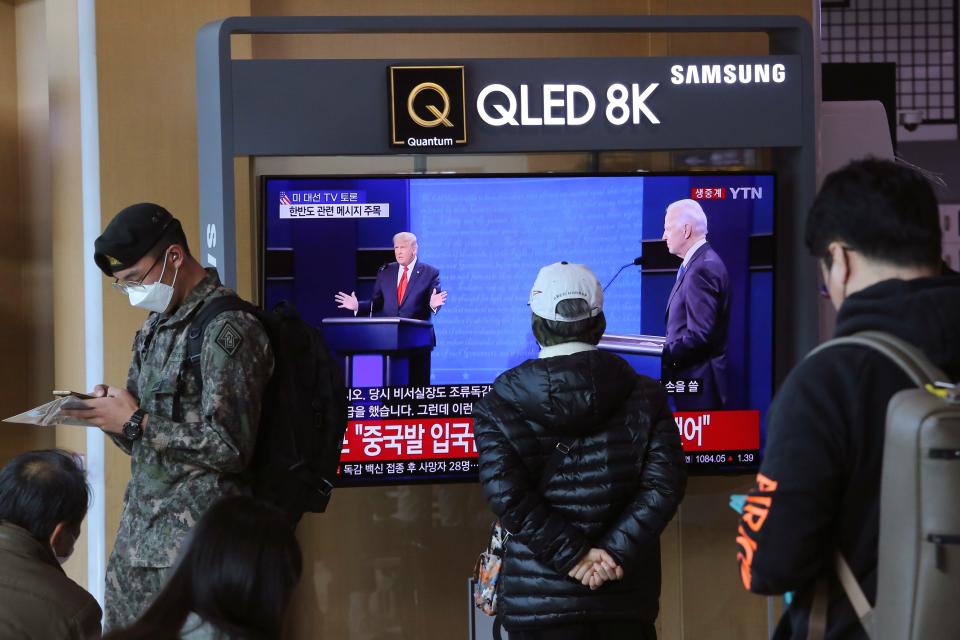 A person in the Seoul Railway Station in Seoul, South Korea, watches a live broadcast of U.S. President Donald Trump and Democratic presidential candidate former Vice President Joe Biden during the final presidential debate.