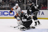 Los Angeles Kings goaltender David Rittich (31) stops a shot by New York Islanders center Casey Cizikas (53) with Kings right wing Adrian Kempe (9) watching during the third period of an NHL hockey game in Los Angeles, Monday, March 11, 2024. (AP Photo/Alex Gallardo)