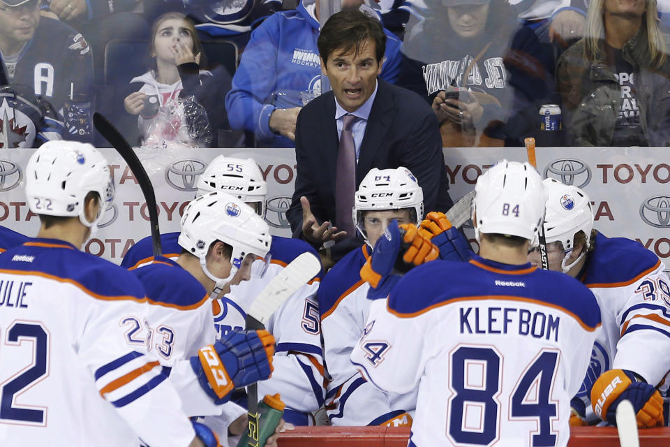 FILE - In this Sept. 24, 2014, file photo, Edmonton Oilers coach Dallas Eakins talks to his team during a timeout during the first period of an NHL preseason hockey game against the Winnipeg Jets, in Winnipeg, Manitoba. Dallas Eakins is the Anaheim Ducks' new coach. The Ducks announced the move Monday, June 17, 2019, filling the NHL's last head coaching vacancy with the veteran coach of their AHL affiliate in San Diego. (AP Photo/The Canadian Press, John Woods, File)