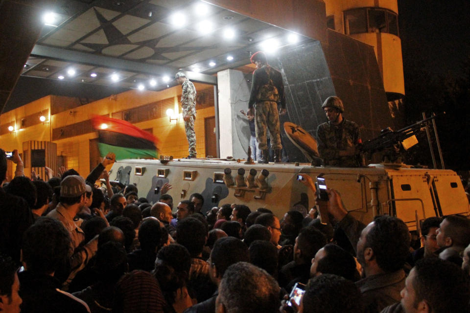 Soldados egipcios permanecen arriba de un vehículo blindado en la entrada de la oficina central de seguridad del estado después de que manifestantes irrumpieron en el lugar en el vecindario de Ciudad Nasr, en El Cairo, Egipto, el sábado 5 de marzo de 2011. (AP Foto/Ahmed Alí)