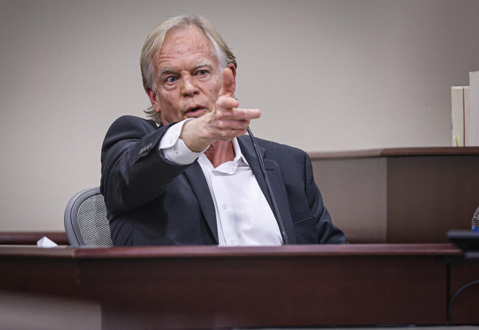 David Halls, former first assistant director on Rust, uses his hand to resemble a gun to  recreate a gesture that Alec Baldwin used while on set the day the Halyna Hutchins was accidentally shot on set, while testifying  during Hannah Gutierrez-Reed’s involuntary manslaughter trial at the First Judicial District Courthouse in Santa Fe on Thursday, Feb. 29, 2024.