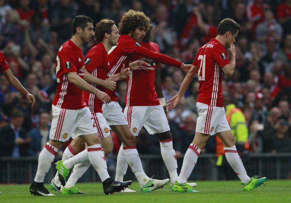 <p>Manchester United’s Marouane Fellaini celebrates scoring their first goal with teammates </p>