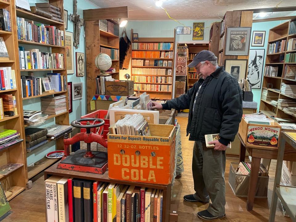 Longtime customer and friend Tracy Weeks checks out the selection at the newest location for The Book Eddy on North Broadway.