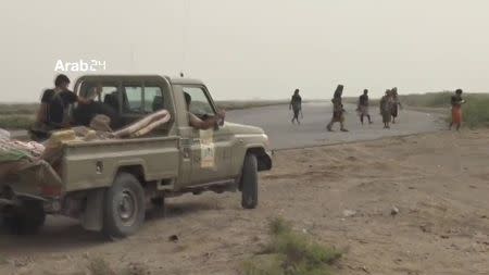 Members of Arab-backed Yemeni forces are driving a truck near the airport on the outskirts of Hodeidah, Yemen, June 20, 2018 in this still image taken from video. ARAB 24 via REUTERS