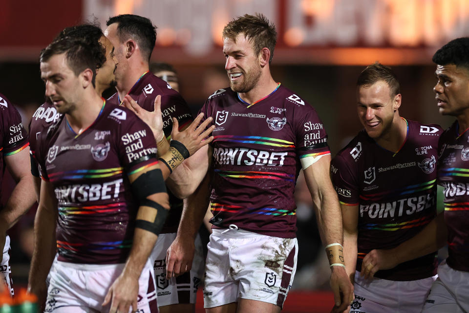 Seen here, Andrew Davey of the Sea Eagles celebrates with teammates after scoring against the Roosters.