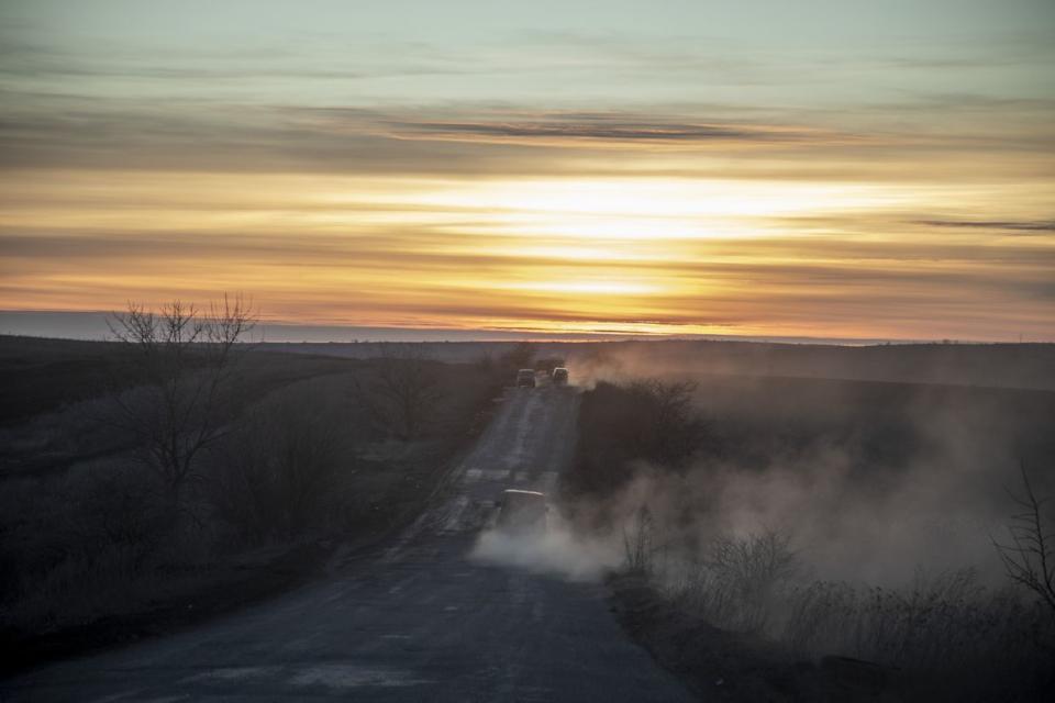 Military vehicles are seen on a road at sunset on the fields nearby Chasiv Yar battlefield as fighting between Ukrainian forces and Russian troops continues on the second year anniversary of the war in Donbas, Donetsk Oblast, Ukraine on Feb. 24, 2024. (Narciso Contreras/Anadolu via Getty Images)