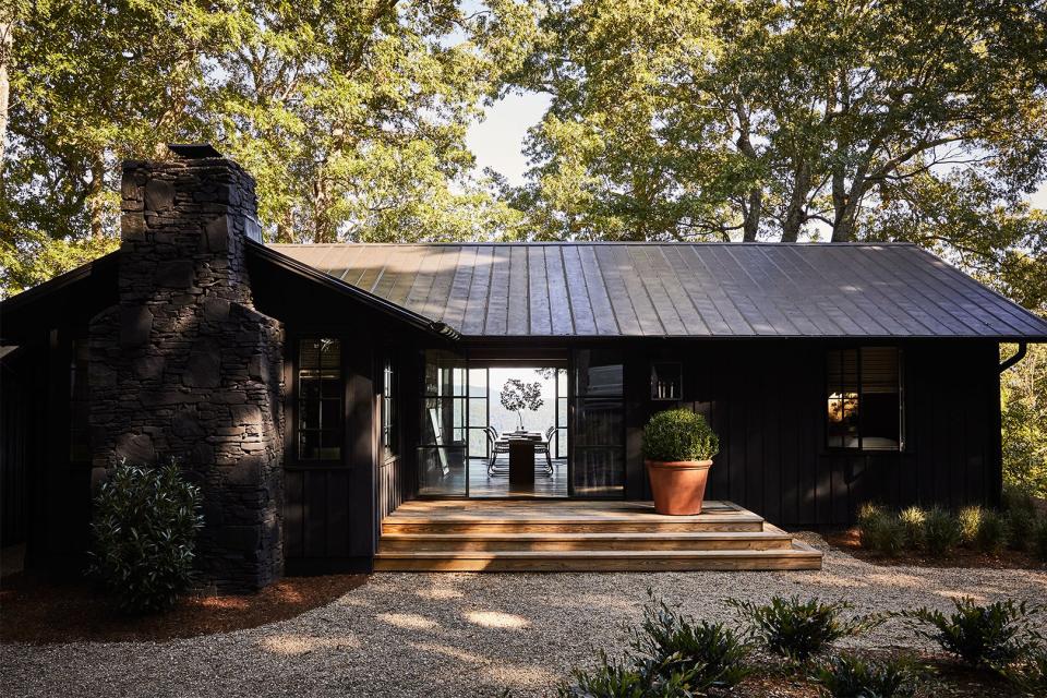 Brick mountain cabin painted black.