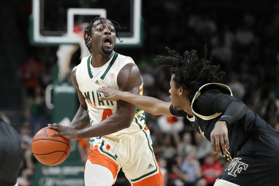 Miami guard Bensley Joseph (4) looks to pass under pressure from Wake Forest guard Tyree Appleby (1), during the first half of an NCAA college basketball game, Saturday, Feb. 18, 2023, Coral Gables, Fla. (AP Photo/Rebecca Blackwell)