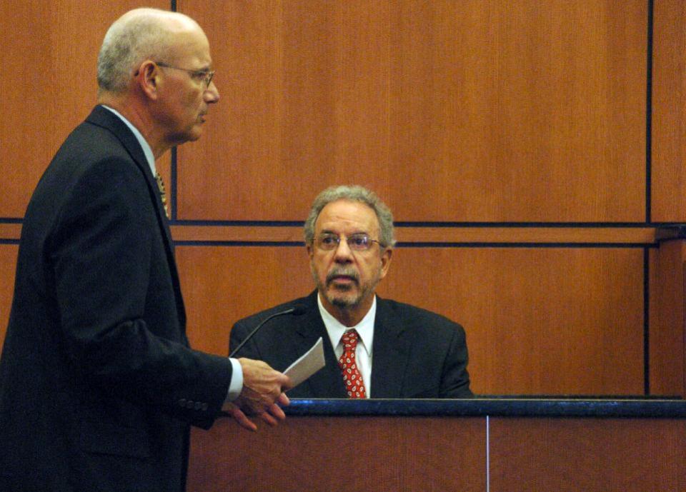 Defense attorney Al Avignone, left, questions psychologist Greg Olley during testimony, Monday, March 24, 2014 in Sidney, Mont. on whether a Colorado man should stand trial in the 2012 killing of a Montana teacher. Olley testified that 24-year-old defendant Michael Keith Spell has an intelligence level comparable to an 11-year-old and is not fit for trial. (AP Photo/Matthew Brown)