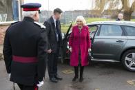 <p>The Duchess of Cornwall arrived at her royal patronage, the National Literacy Trust, wearing a magenta coat over a paisley print dress with black boots and a black handbag. Camilla accessorized the look with a pearl choker, pearl drop earrings, and a brooch. </p>