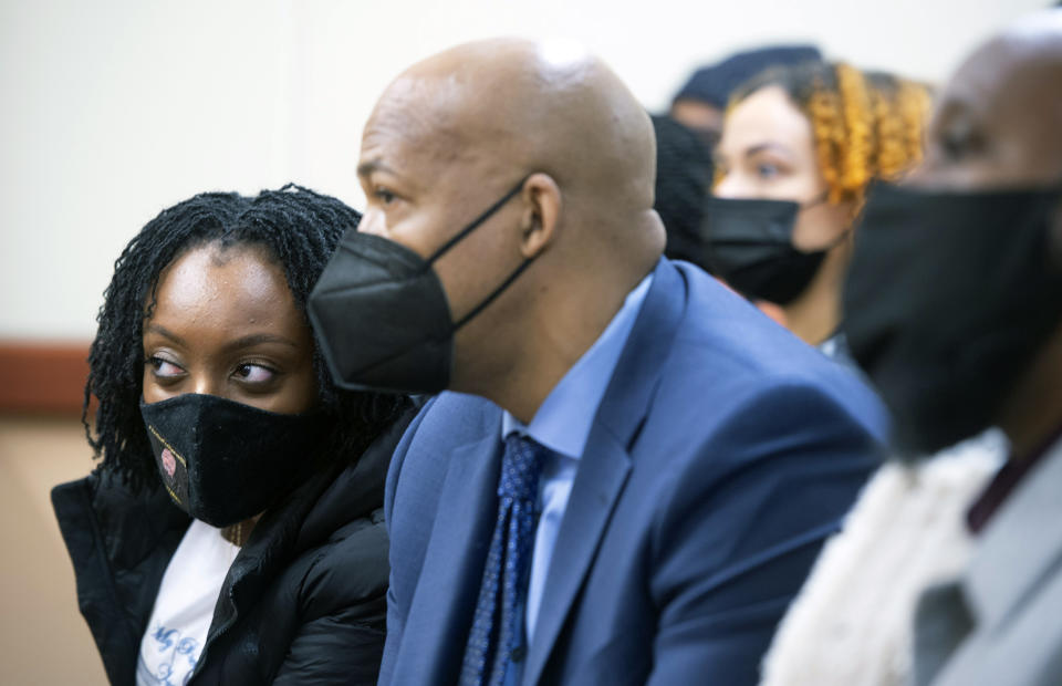 Monet Carter-Mixon, left, the sister of Manuel Ellis, sits with family members and attorney James Bible as they watch the Pierce County Superior Court arraignment appearances of three Tacoma police officers, Friday, May 28, 2021 in Tacoma, Wash. Three Washington state police officers pleaded not guilty Friday in the death of Manuel Ellis, another Black man who pleaded for breath under an officer's knee. (Tony Overman/The News Tribune via AP, Pool)