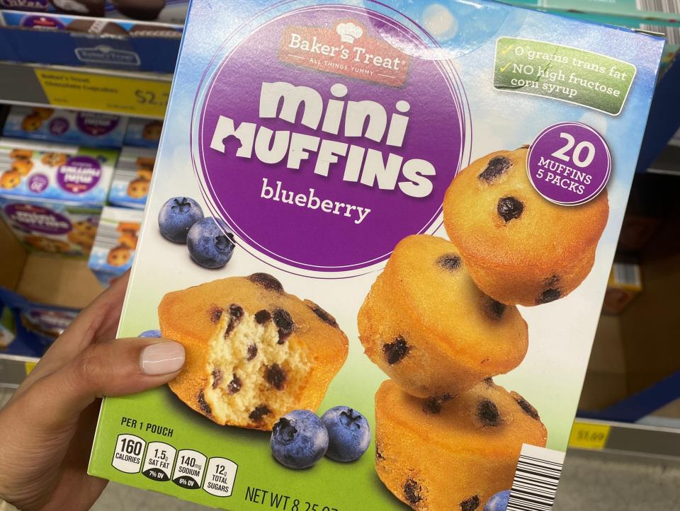 Hand holding a box of mini muffins at ALdi