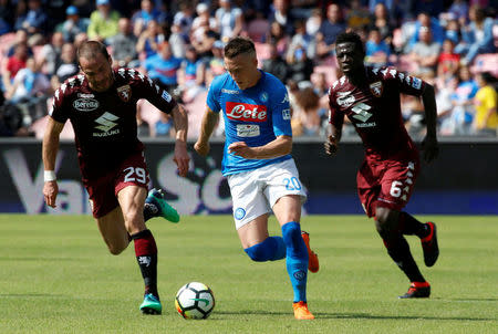 FILE PHOTO: Naples, Italy - May 6, 2018 Napoli's Piotr Zielinski in action with Torino's Lorenzo De Silvestri and Afriyie Acquah REUTERS/Ciro De Luca/File Photo