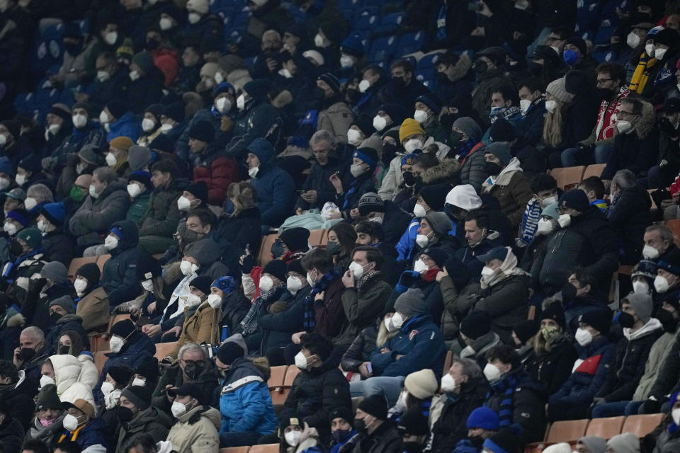 Inter soccer fans wait for the start of the Serie A soccer match between Inter Milan and Lazio at the San Siro Stadium, in Milan, Italy, Sunday, Jan. 9, 2022. With Italy's hospital ICUs rapidly filling up with COVID-19 patients, most of them unvaccinated, Premier Mario Draghi’s government issued a Christmas Eve decree that FFP2 masks – which are more protective for users than cloth or surgical face masks – must be worn used on public transport, including planes, trains, ferries and local buses, trams and subways. (AP Photo/Antonio Calanni)