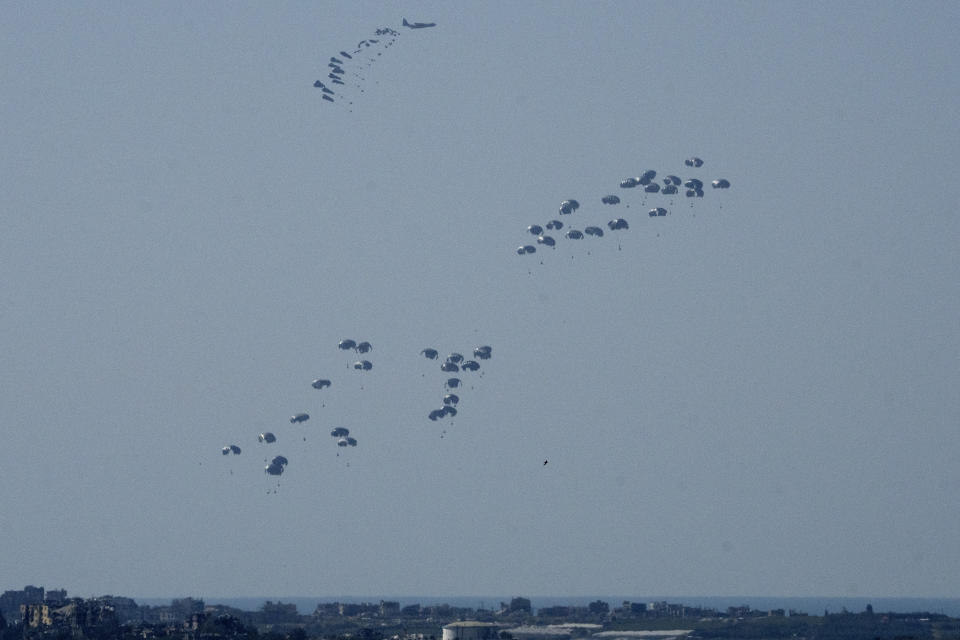 Parachutes drop humanitarian aid into the northern Gaza Strip, as seen from southern Israel, Monday, March 11, 2024. (AP Photo/Maya Alleruzzo)