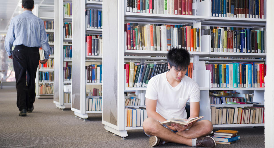A student studies in a university library.