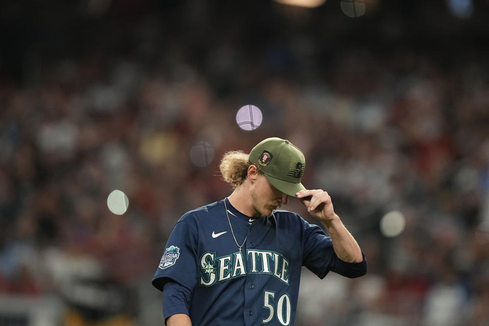 Seattle Mariners starting pitcher Bryce Miller walks off the field in the seventh inning of a baseball game against the Seattle Mariners, Friday, May 19, 2023, in Atlanta. (AP Photo/Brynn Anderson)