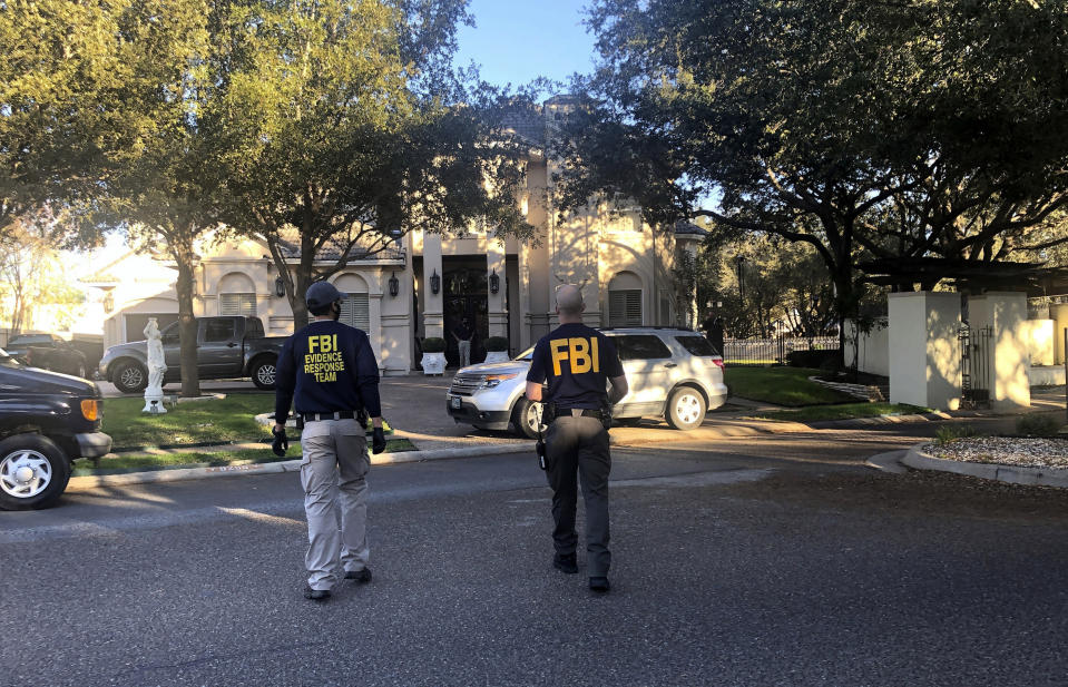 FILE - Federal agents search the home of Rep. Henry Cuellar, D-Texas, in Laredo, Texas, Jan. 19, 2022. Cuellar and his wife were indicted on conspiracy and bribery charges and taken into custody Friday, May 3, 2024, in connection with a U.S. Department of Justice probe into the couple's ties to the former Soviet republic of Azerbaijan. (Valarie Gonzalez/The Monitor via AP, File)