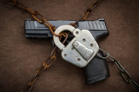 Handgun under padlock and chain