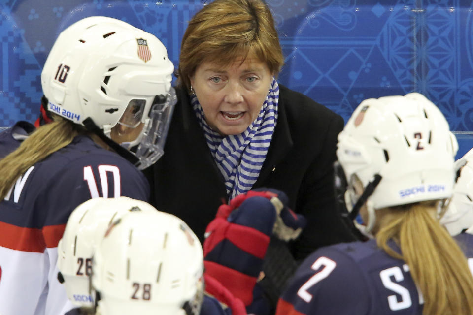 USA head coach Katey Stone talks to the team during a break in the action at the 2014 Winter Olympics women's ice hockey game between Canada and the United States at Shayba Arena, Wednesday, Feb. 12, 2014, in Sochi, Russia. (AP Photo/J. David Ake)