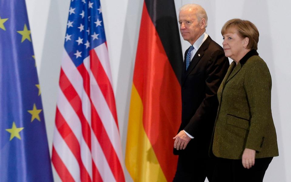 Mr Biden with Angela Merkel in 2013. The President-elect has the support of Germans, according to a new poll - AP