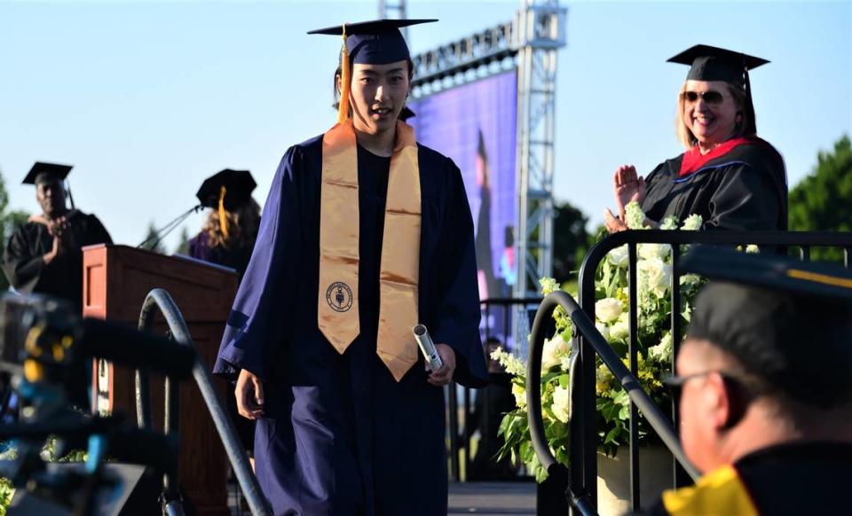 Merced College graduate Yudai Watanabe makes her way off the stage after receiving her degree during the school’s 60th commencement ceremony on Friday, May 26, 2023.