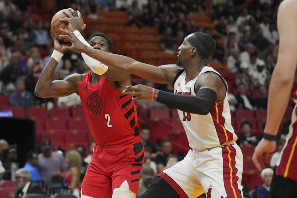 Portland Trail Blazers center Deandre Ayton (2) takes a shot over Miami Heat center Bam Adebayo (13) during the first half of an NBA basketball game, Friday, March 29, 2024, in Miami. (AP Photo/Jim Rassol)