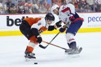 Washington Capitals' T.J. Oshie, right, tries to get past Philadelphia Flyers' Cam York during the third period of an NHL hockey game, Tuesday, April 16, 2024, in Philadelphia. (AP Photo/Matt Slocum)