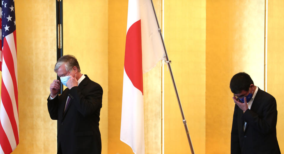 U.S. Deputy Secretary of State Stephen Biegun, left, the top U.S. official on North Korea, and Japan's Defense Minister Taro Kono, wearing face masks, arrive for a bilateral meeting in Tokyo Friday, July 10, 2020. (Behrouz Mehri/Pool Photo via AP)