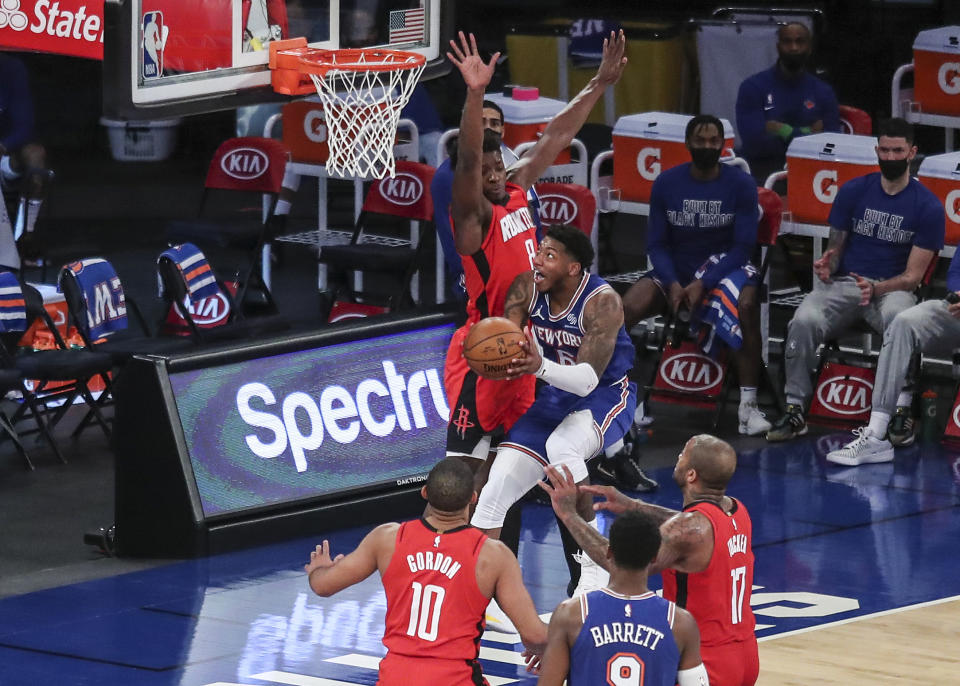 New York Knicks guard Elfrid Payton (6) drives in for a layup against the Houston Rockets during the second quarter of an NBA basketball game Saturday, Feb. 13, 2021, in New York. (Wendell Cruz/Pool Photo via AP)