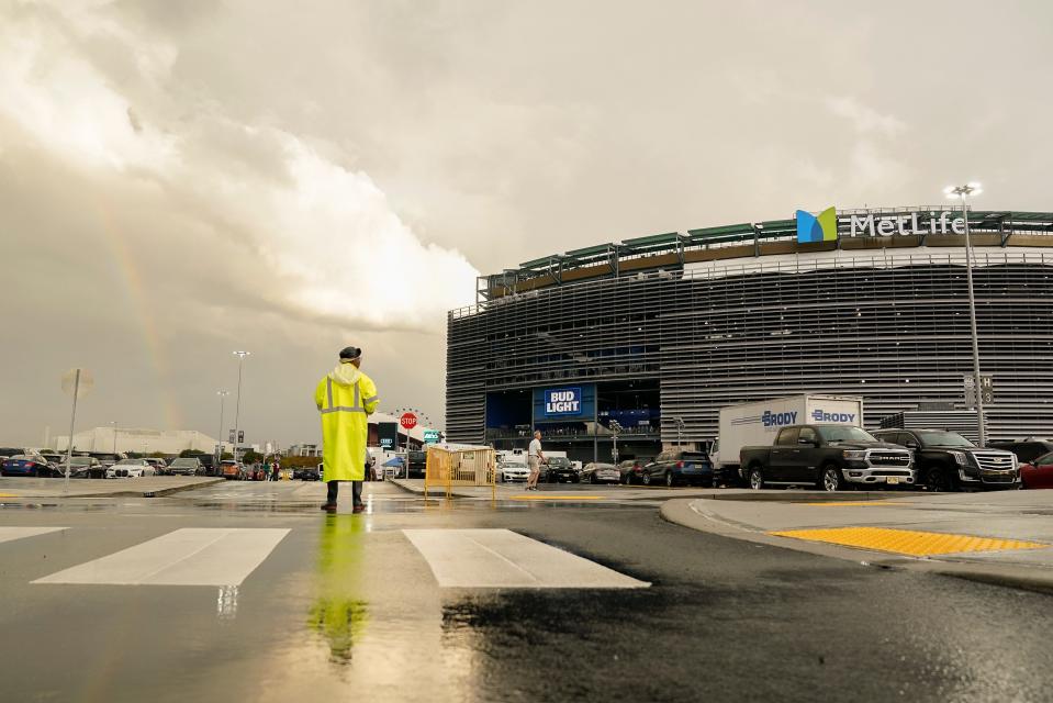 A parking attendant views a rainbow outside Met Life stadium before an NFL football game between the New York Jets and the Buffalo Bills, Monday, Sept. 11, 2023, in East Rutherford, N.J. (AP Photo/Seth Wenig)