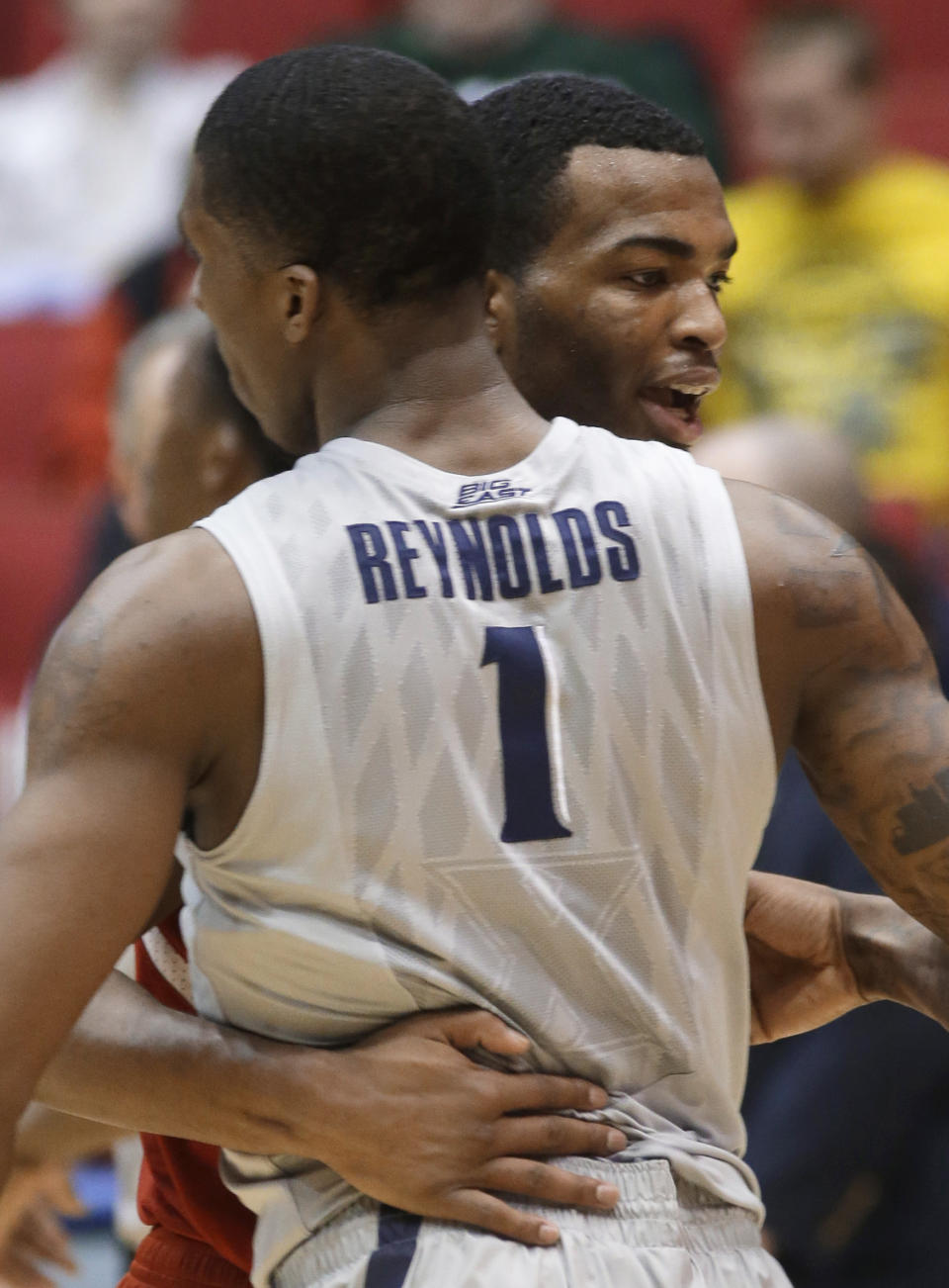 North Carolina State forward T.J. Warren hugs Xavier forward Jalen Reynolds (1) after NC State defeated Xavier 74-59 in a first-round game of the NCAA college basketball tournament, Tuesday, March 18, 2014, in Dayton, Ohio. (AP Photo/Al Behrman)