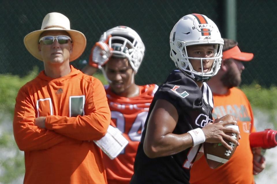 Miami coach Mark Richt, left, watches as quarterback Brad Kaaya, right, prepares to pass during practice. (AP Photo/Alan Diaz)