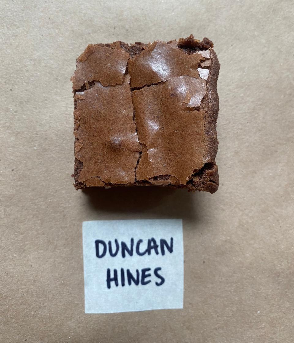 A homemade brownie on a plain surface with a 