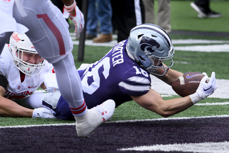 Kansas State wide receiver Seth Porter (16) dives into the end zone for a touchdown while being tackled by Houston defensive lineman Cavan Tuley, left, during the second half of an NCAA college football game in Manhattan, Kan., Saturday, Oct. 28, 2023. (AP Photo/Reed Hoffmann)