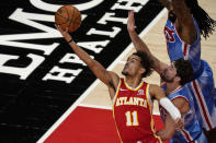 Atlanta Hawks' Trae Young (11) shoots next to Brooklyn Nets' Joe Harris, lower right, during the first half of an NBA basketball game Wednesday, Jan. 27, 2021, in Atlanta. (AP Photo/Brynn Anderson)