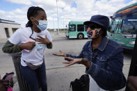 Wendy Caldwell-Liddell, left, who helped start Mobilize Detroit, a newly formed grassroots organization, talks to Margaret Roberts about voting in Detroit, Friday, Sept. 18, 2020. Both President Donald Trump and Democratic presidential nominee Joe Biden are battling for support among Black voters across Michigan, and Biden's running mate, Sen. Kamala Harris, will be in the state on Tuesday, Sept. 22. (AP Photo/Paul Sancya)