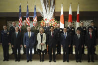 Merrill Eisenhower Atwater, the great-grandson, third left bottom, and Mary Jean Eisenhower, granddaughter of former U.S. President Dwight D. Eisenhower, center bottom left, and Japan's Prime Minister Shinzo Abe, center right bottom, with other guests pose for a group photo session as part of the 60th Anniversary commemorative reception of the signing of the Japan-U.S. Security Treaty at Iikura Guesthouse in Tokyo, Sunday, Jan. 19, 2020. (AP Photo/Eugene Hoshiko, Pool)