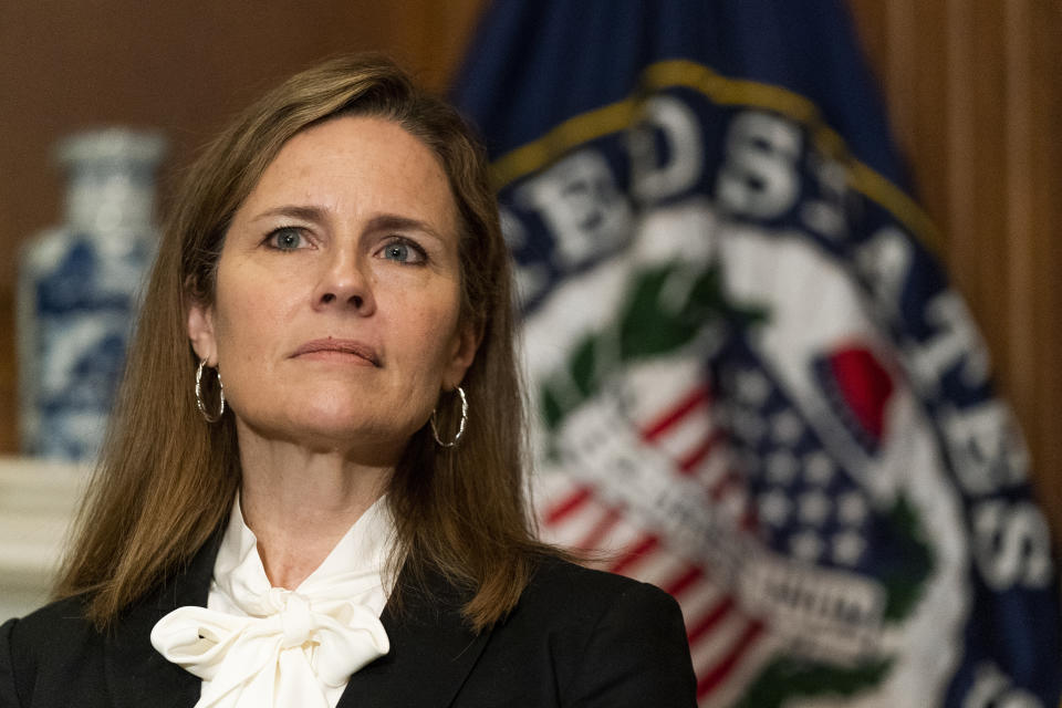 FILE - In this Oct. 1, 2020, file photo President Donald Trump's Supreme Court nominee Judge Amy Coney Barrett listens as Sen. Jerry Moran, R-Kan., not shown, speaks during their meeting on Capitol Hill in Washington. Democrats are treading carefully on religious faith as they prepare to question President Donald Trump's Supreme Court nominee. (AP Photo/Manuel Balce Ceneta, Pool)