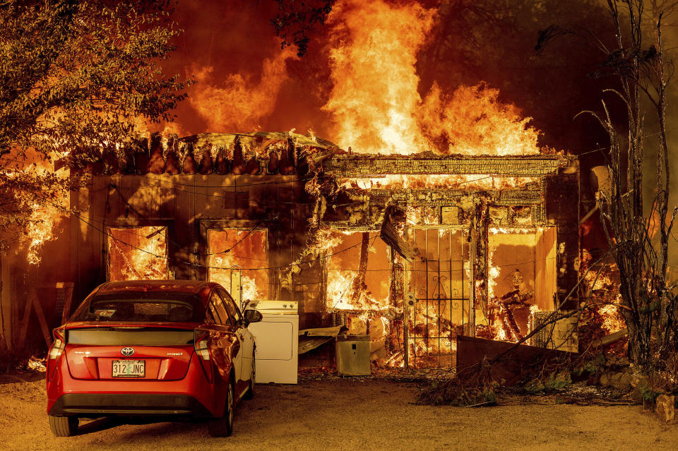 Fire consumes a home as the Sugar Fire, part of the Beckwourth Complex Fire, tears through Doyle, Calif., on Saturday, July 10, 2021. Pushed by heavy winds, the fire came out of the hills and destroyed multiple residences in central Doyle. (AP Photo/Noah Berger)