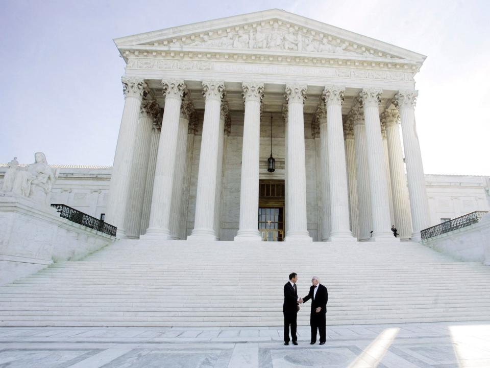 Supreme Court Chief Justice John Roberts, left, and Justice John Paul Stevens, stand in front of the U.S. Supreme Court, Monday, Oct 3, 2005 in Washington.