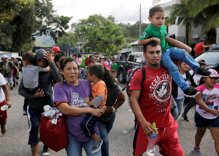 Honduran migrants, part of a caravan trying to reach the U.S., react after crossing the border between Honduras and Guatemala, in Agua Caliente, Guatemala October 15, 2018. REUTERS/Jorge Cabrera