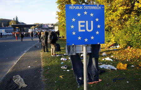 Migrants rest at the Austrian Slowenian border near the village of Spielfeld, Austria, October 24, 2015. REUTERS/Leonhard Foeger