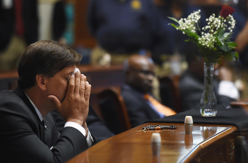 State Senator Vincent Sheheen (D-Kershaw) gets emtional as he sits next to the draped desk of state Sen. Clementa Pinckney, Thursday, June 18, 2015, at the Statehouse in Columbia, S.C.  Pinckney was one of those killed, Wednesday night in a shooting at the Emanuel AME Church in Charleston. 